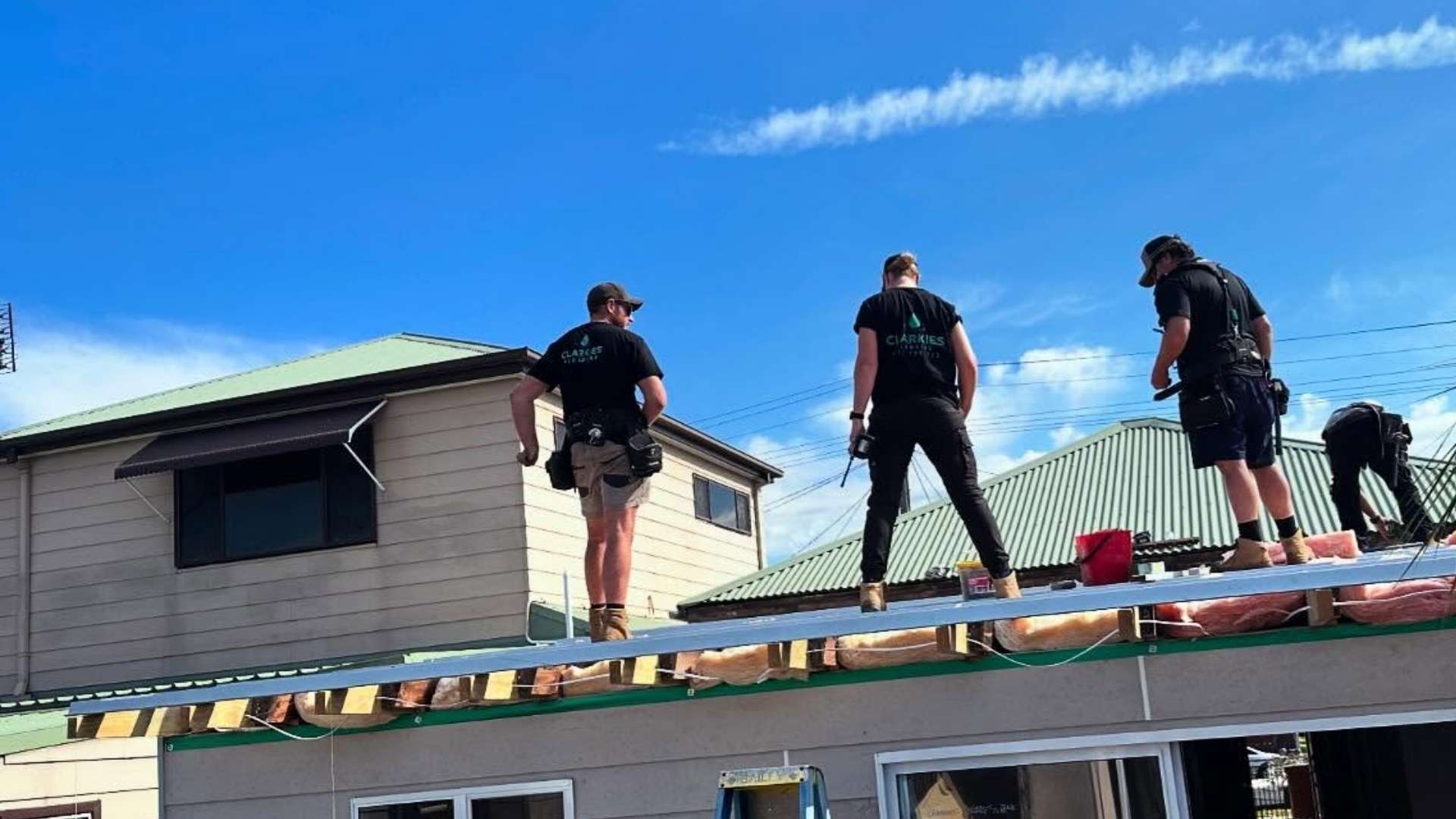 Four Clarkies plumbers are making repairs on the roof.