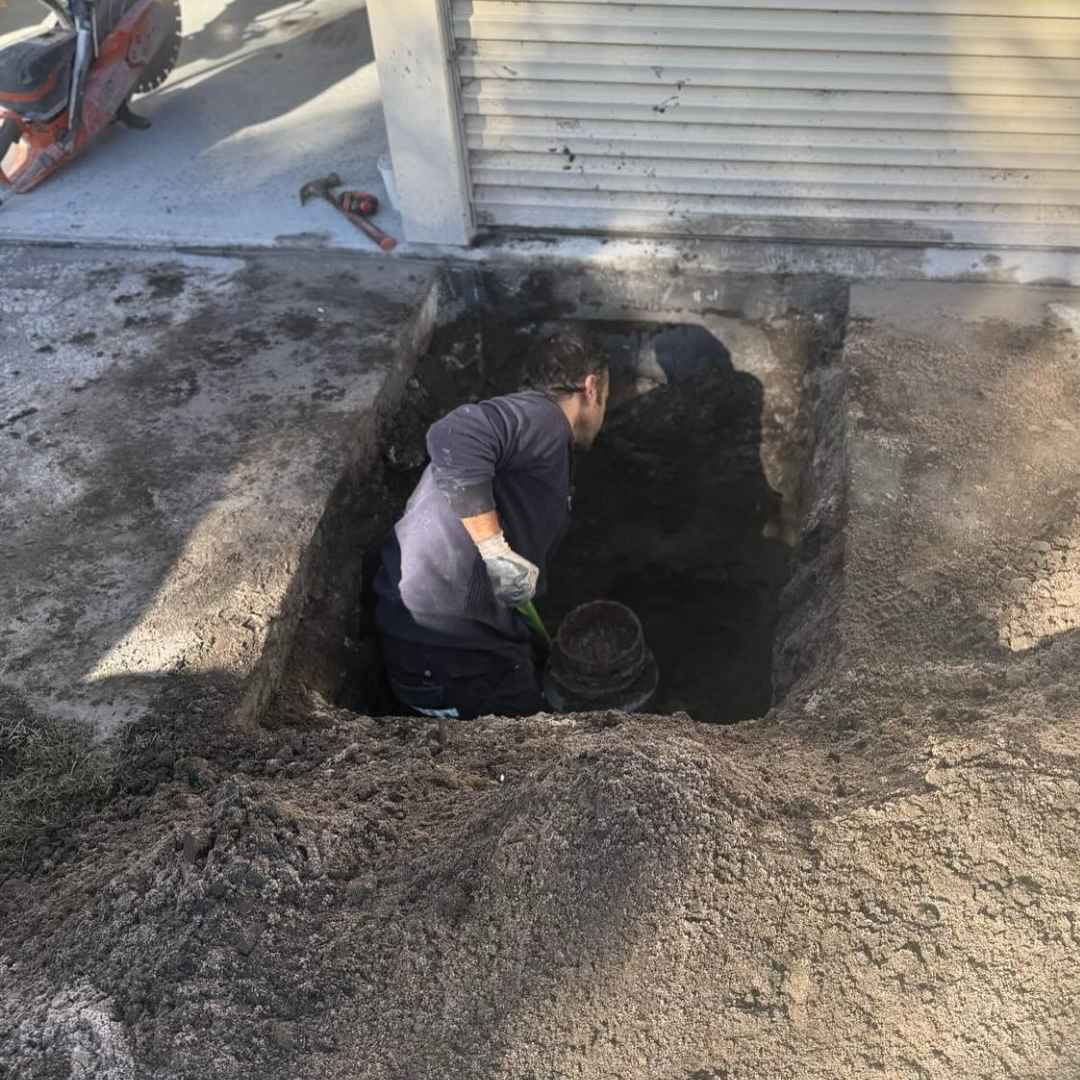 Clarkies Plumber is Digging Beside the House