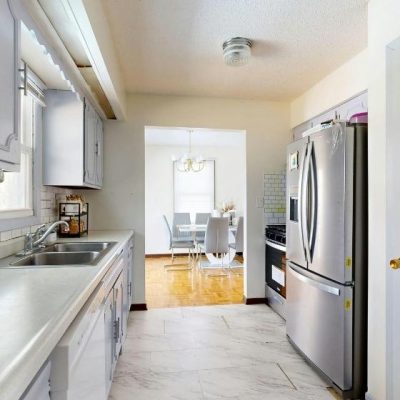 Residential kitchen with sink and installed appliances